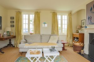 Image of a lounge with a nest of coffee tables and a couple of windows