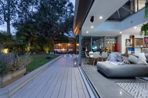 Twilight image of the lounge with the bi-folding doors open to the garden