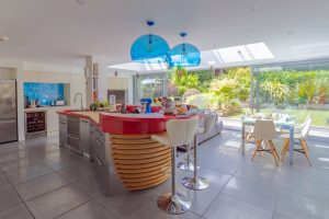 Image of the kitchen/diner and TV room with a view to the garden