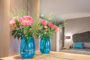 Image of flowers in a jar and its own reflection