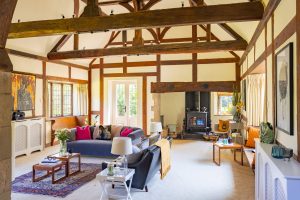 Image of the lounge and inglenook with woodburner at the end