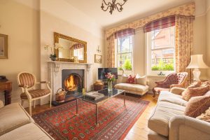 Image of the sitting room with the fire on